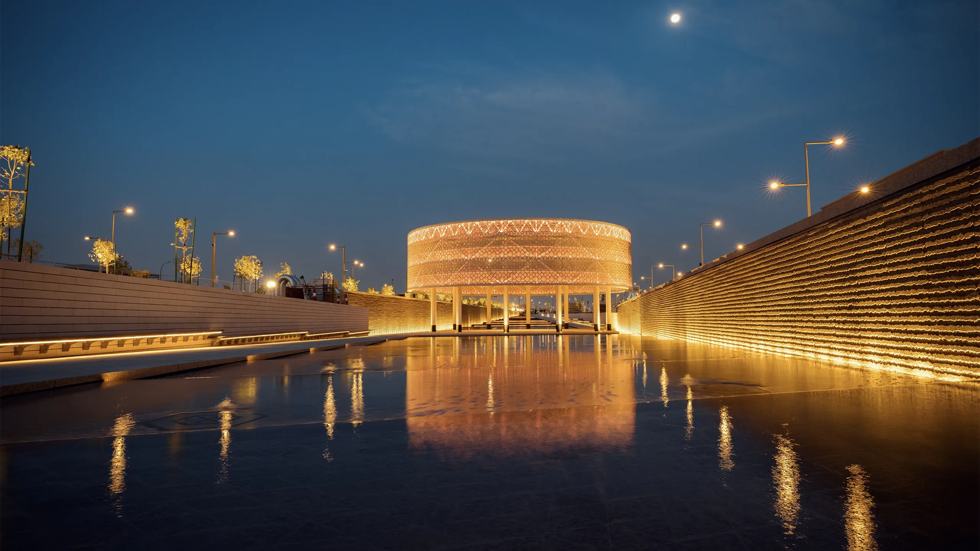 Sports Boulevard at night, illuminating golden colour with wet pathway, Kingdom of Saudi Arabia