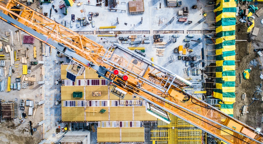 Nadir view of an industrial site, with cranes, concrete work, and more.