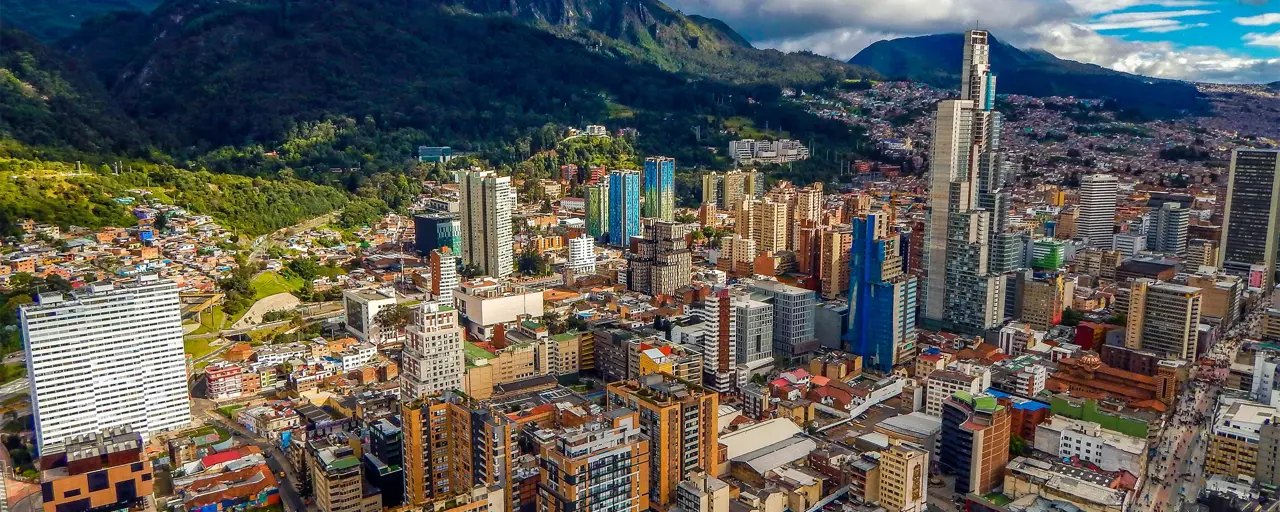 Bogota Cityscape Of Big Buildings And Mountains And Blue Sky